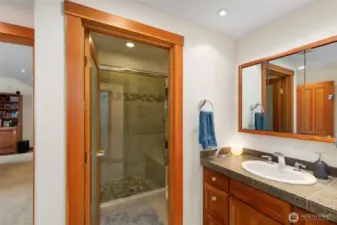 This 3/4 bath off the rec room boasts updated tile shower. On the other side of the room is access to two storage areas and utility room.