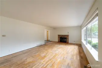 Living room with wood burning fireplace.