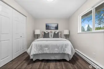 One of three bedrooms looks out to a private backyard. Laminate flooring throughout the home opens up each room to feel large and spacious.