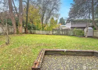 Back patio, fenced back yard and mature landscaping.
