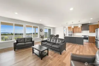 Inviting great room with abundant natural light and modern kitchen backdrop.