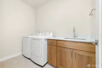 Laundry room including sink & storage.