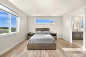 Contemporary owner's suite with sleek lines and large windows as well as a spacious private owner's bath.