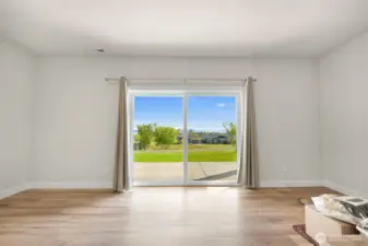 Expansive ground floor flex space with abundant natural light and walk out access, perfect for a recreation room, studio or additional living area.