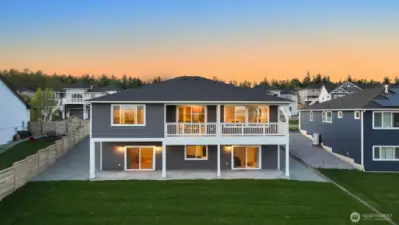 Gorgeous level backyard with wide covered patio and deck ideal for entertaining or relaxing outdoors.