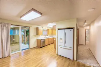 Sparkling clean and ready to move-in. View to kitchen and hallway to bedrooms.