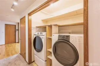 Full-size washer and dryer in the hall on the way to the bedrooms. Door on the left goes to the converted garage area with 2nd bathroom.