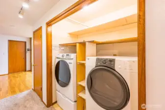 Full-size washer and dryer in the hall on the way to the bedrooms. Door on the left goes to the converted garage area with 2nd bathroom.
