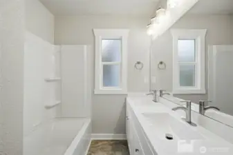 Updated full Bathroom w/ dual vanity, tile, tub & shower.