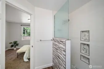 Tiled walk-in shower in the primary suite.