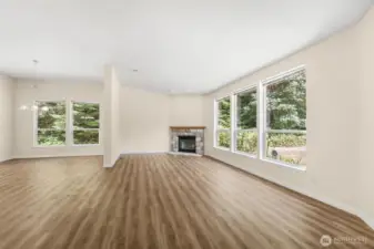 Living with wood burning fireplace and open concept.