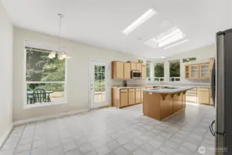The kitchen opens up onto the 16.6x55 Timber Teck deck and backyard with fire pit.
