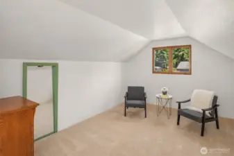 Sitting area in primary bedroom with gas fireplace.
