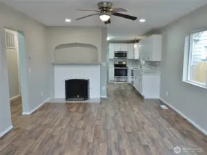 Living Room w/ ceiling fan and classic fireplace.