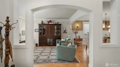 New pre-finished hardwood floors, crown moulding, arched room entries, and plenty of natural light drench the living spaces during the day