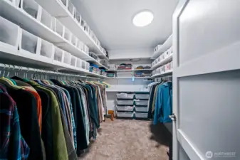 One of two primary closets, with extensive shelving for storage that is able to be reconfigured as you like it