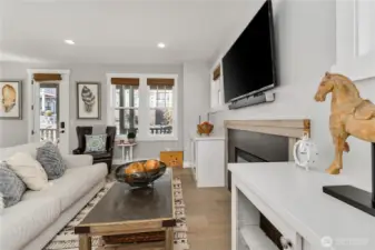 Living room with high quality furnishings and decor, fireplace and built in cabinets.