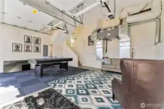 View of attached 2-car garage with lounge and game area.