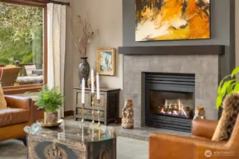 Double sided see through gas fireplace with contemporary surround and mantle.