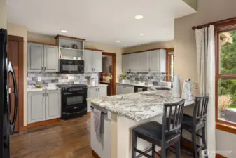 Updated kitchen with slab stone counters and lots of storage!