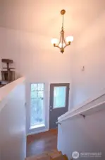 Beautiful view from the upper landing overlooking the inviting front entryway.