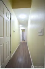 Interior hallway connecting the main living areas to the bedrooms.