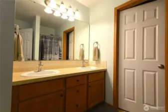 Convenient dual-sink vanity in the primary bath offering space and functionality.