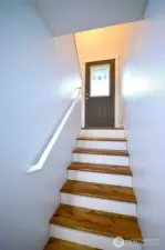 Perspective from the downstairs area showcasing the inviting front door and entryway.