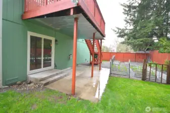 Covered downstairs deck designed for comfortable outdoor living and entertaining.