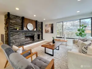 Light filled living room with stone fireplace