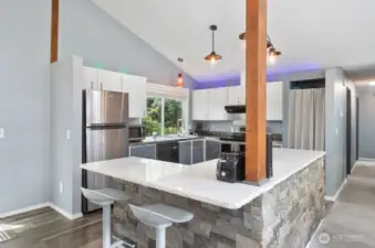 Enter into the open kitchen/dining room