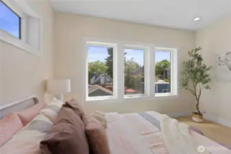 Bright and airy third bedroom flooded with natural light, featuring massive walk in closet complete with a window.