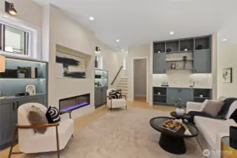 Expansive living room features sweeping cielings and a sleek electric fireplace-creating a bright, airy, and inviting space. Perfect for both relaxation and entertaining.
