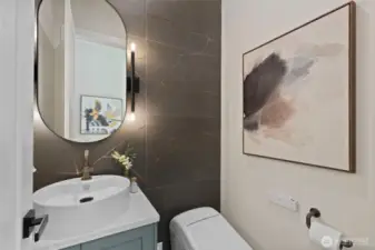 Conveniently located bathroom near entry, featuring a high end TOTO washlet and upsalce finishes that combine luxury and function.