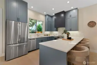Refrigerator features stylish french doors that blend seamlessly with the kitchen cabinetry for a sleek look.