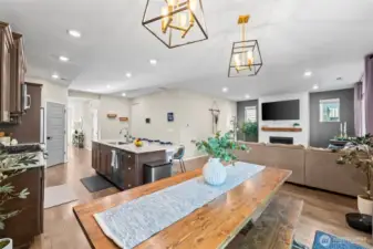 Dining space with modern chandelier and open layout, offering room for large dinner parties.