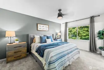 Luxurious primary suite with a ceiling fan, large windows, and serene backyard views at 32540 Granite Ct.