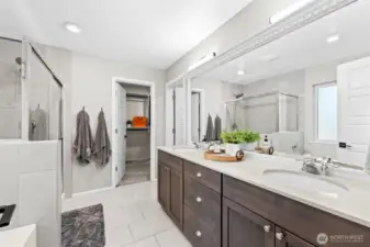 Elegant primary bathroom featuring double vanity, quartz counters, and modern fixtures.