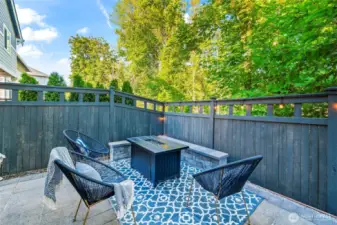 Fully fenced backyard with private seating area and space for outdoor dining.