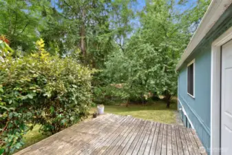 Entertain on the large backyard deck, with room outdoors for gardening and play, bordered by the natural privacy of mature trees.