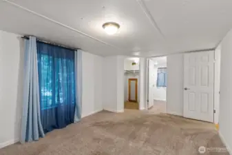 Primary bedroom with a walk in closet and attached private bath.