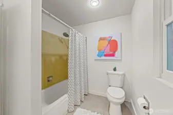 The main bathroom sits wonderfully situated in the hallway for easy access from each of the bedrooms. Convenience is key.