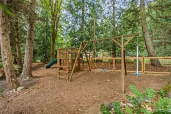 At the top of the property, a play structure begs to be enjoyed! Swing! Climb! Slide! Play!! All within sight of the kitchen and family room windows, for peace of mind.