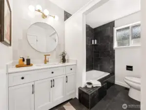 Primary suite with a spa-like bathroom featuring a modern tiled rain shower with floor-to-ceiling modern tile and adjacent horizontal zellige tile running counter to ceiling — a stunning design statement.