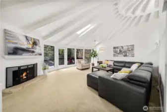 Ling room opens to an elevated deck overlooking a private backyard & tranquil greenbelt