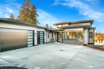 New NW Contemporary with Modern elements includes 3 car garage, EV charging and room for plenty of guests to park.