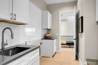 Laundry/Mud room + utility closet w/ furance and tankless water heater.