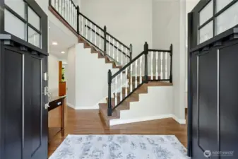 Refreshed hardwood floors in an espresso color, new front doors and look at the 2 story entry.