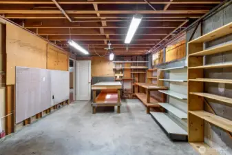 This basement workspace connects to the two-car garage via an internal back staircase — practical, functional, and full of possibility.