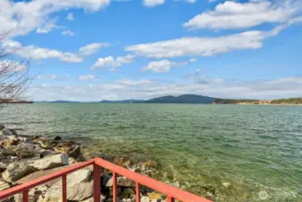 The lot extends down to the water, and the old railroad area below is subject to an easement annexed to the City for a future waterfront trail. Buyer to verify exact details.